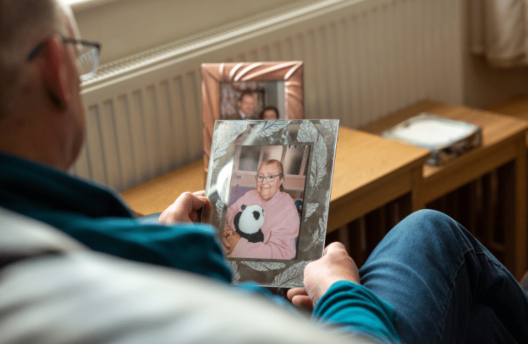 Fred looking at a photo of Lynne.