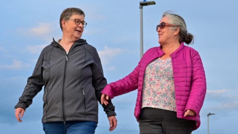 two women walking and chatting