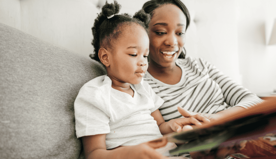 Mum and daughter reading a book together