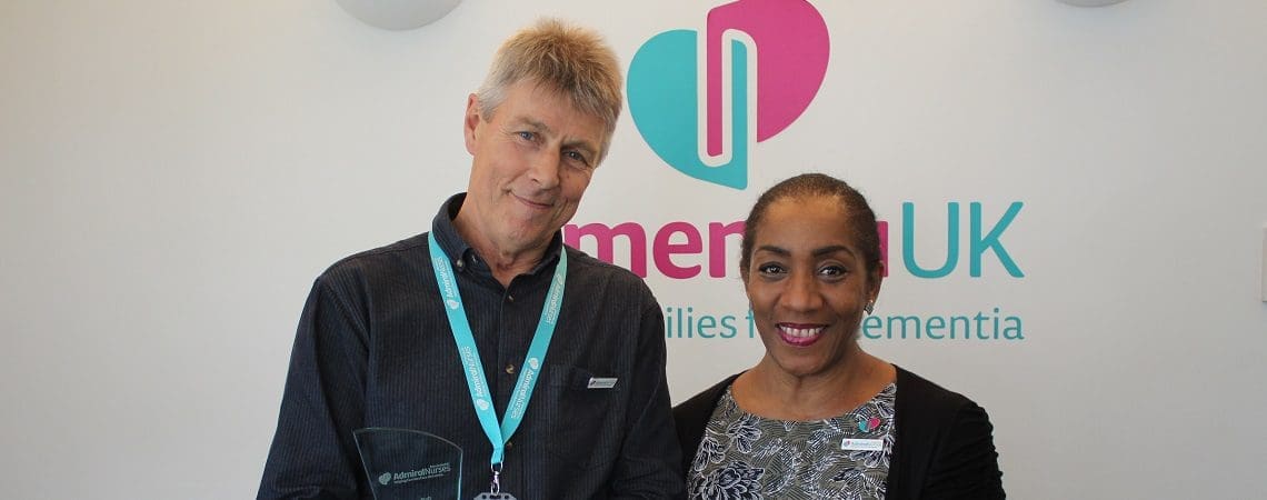 Admiral Nurse Dave and Susan standing in front of Dementia UK banner