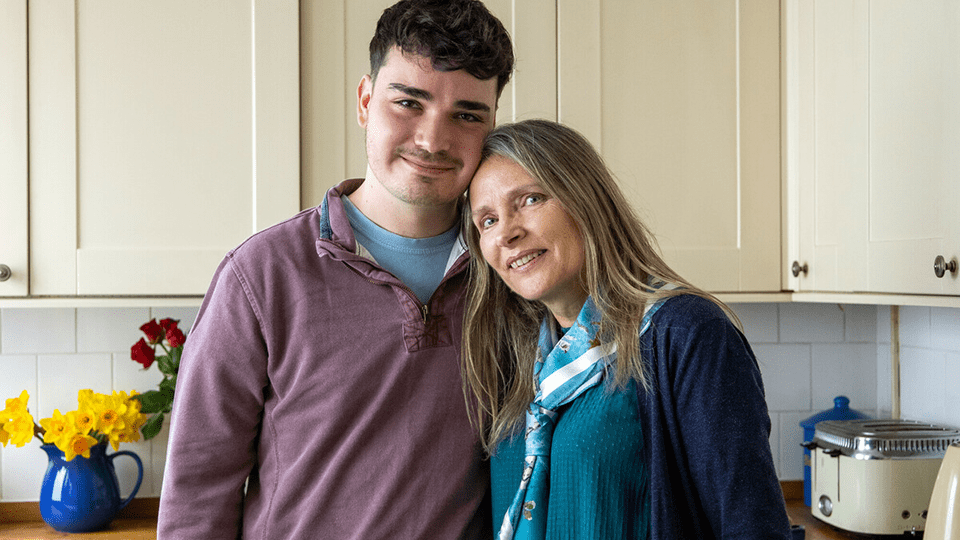 Elliott and his mother Janet smile at the camera