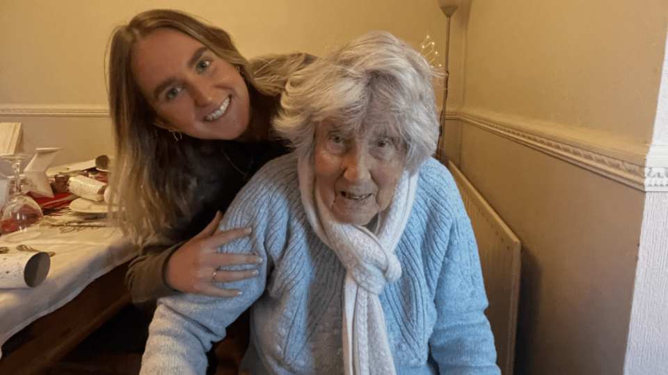 Evie standing behind her nan, who lived with dementia