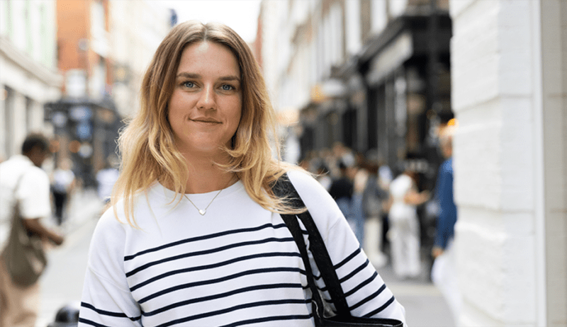 Lizzie stands in a crowded city area