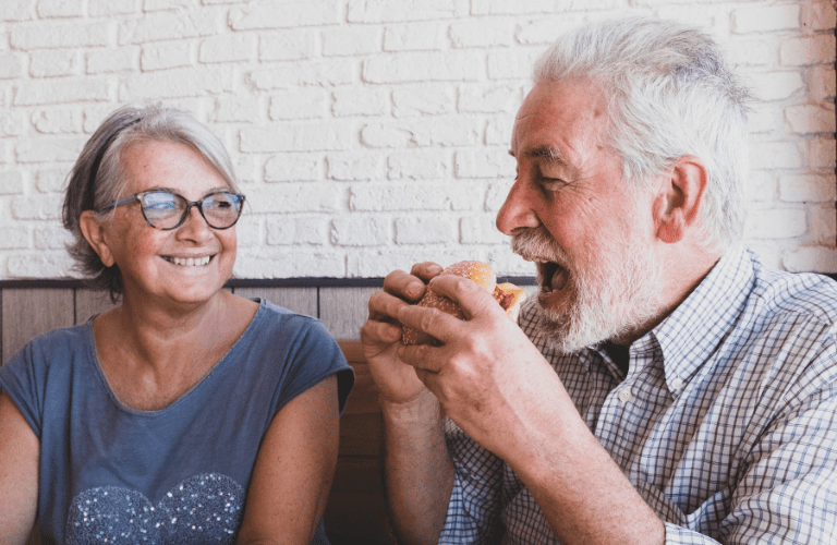 An older couple eat out at a restaurant