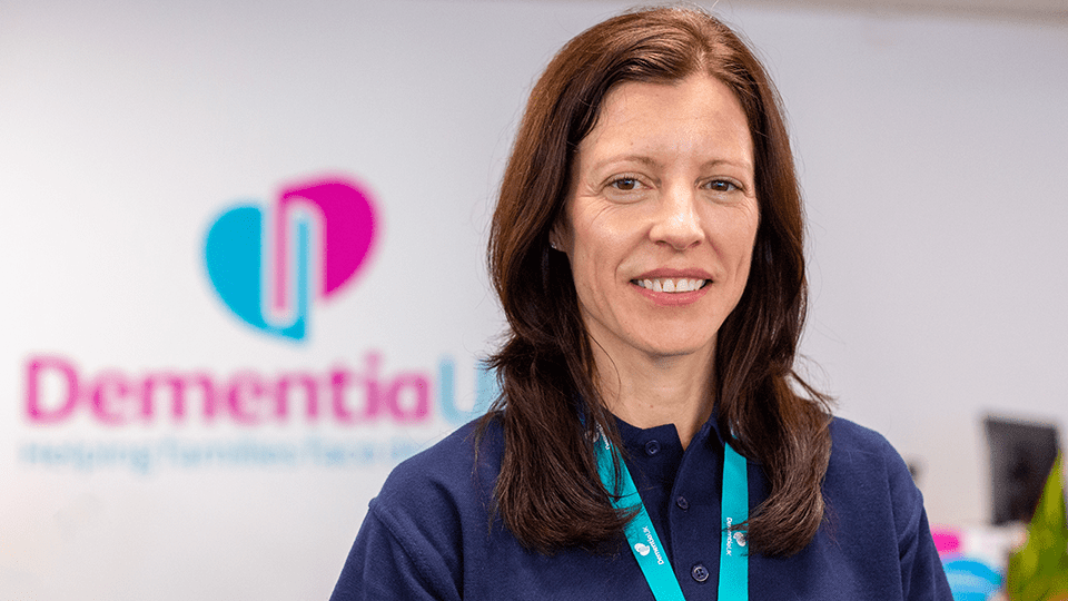 Hannah Gardner smiles at camera in Dementia UK office