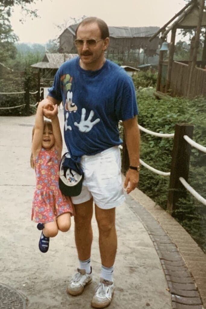 Rob holds a young Lizzie up with his right arm