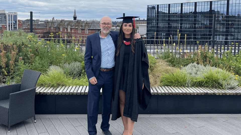 Izzy and her dad at graduation
