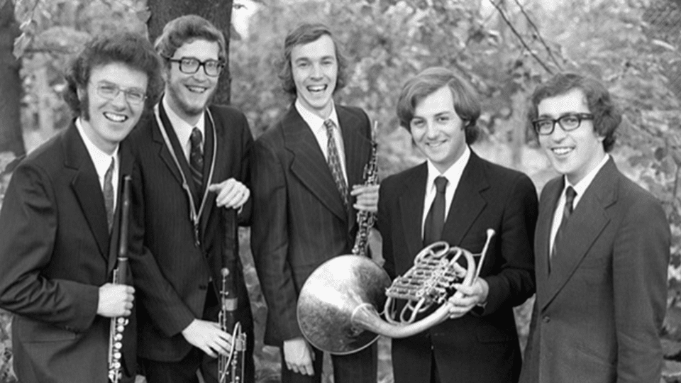 Charles smiles alongside his bandmates