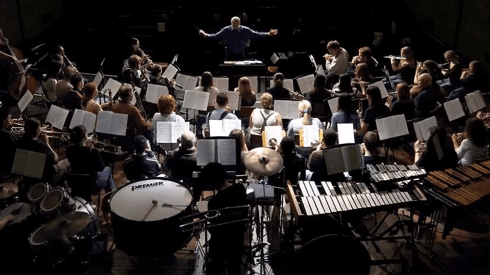 Charles conducts an orchestra