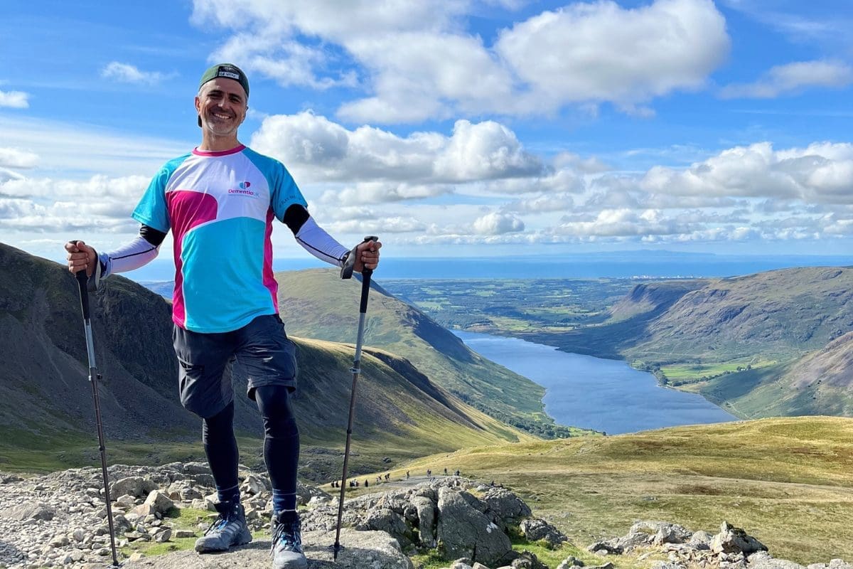 Man standing on top of mountains after completing a hike