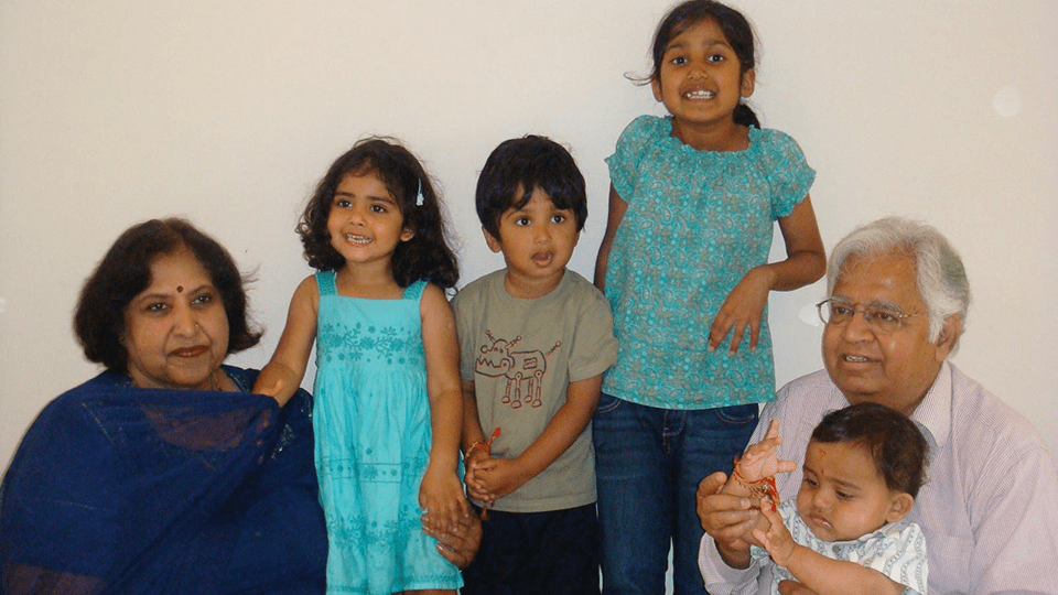 Pratibha and her family huddle for a photo