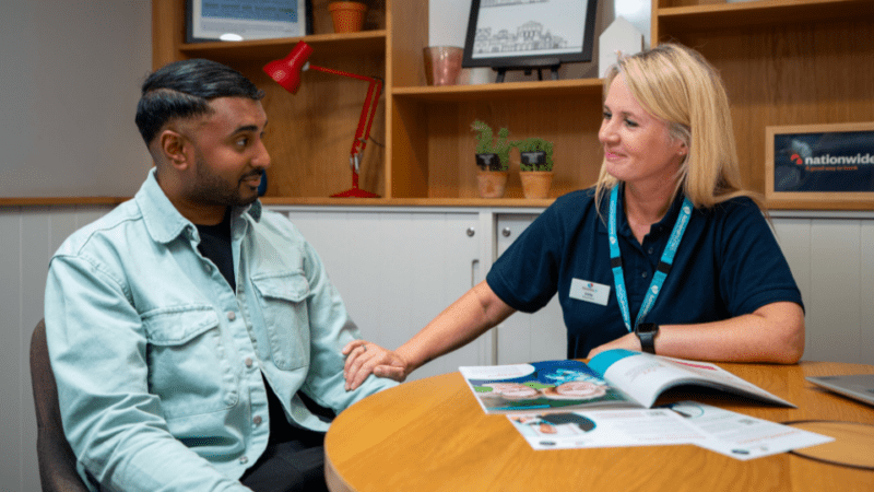 Admiral Nurse (on right) talking to man at a face-to-face clinic
