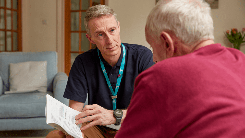 Gary, Admiral Nurse, talking to family carer.