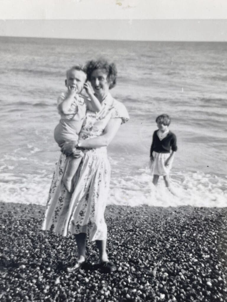 Peggy holds a young Richard by the sea