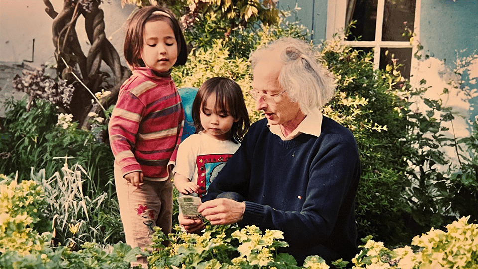 Ralph, who lives with dementia, plays in the garden with a young Saina and her sister