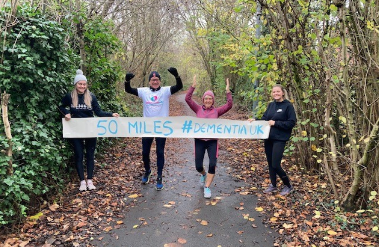 Four Dementia UK runners running in a park