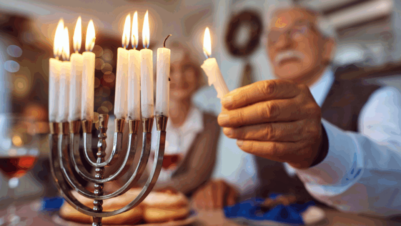 Man lighting the menorah at Hanukkah