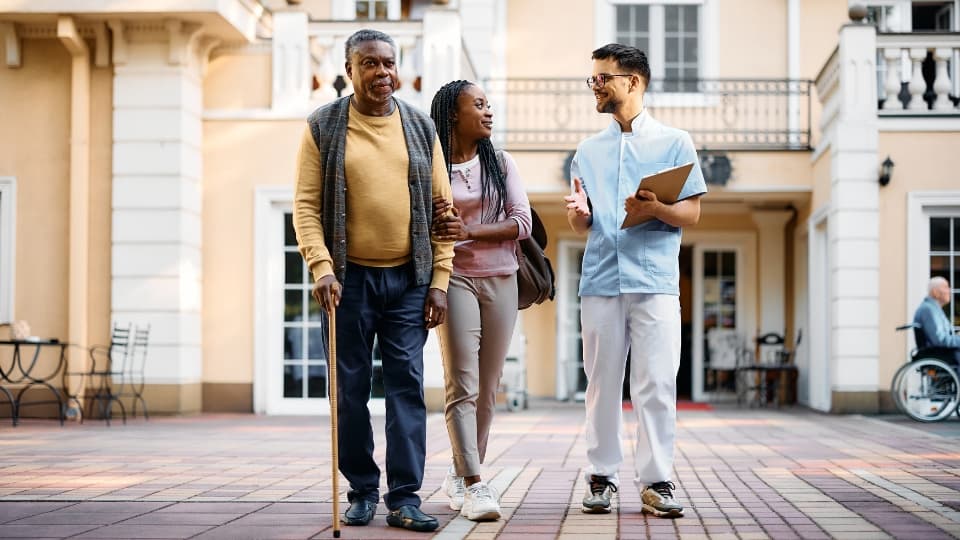 three people walking through a courtyard