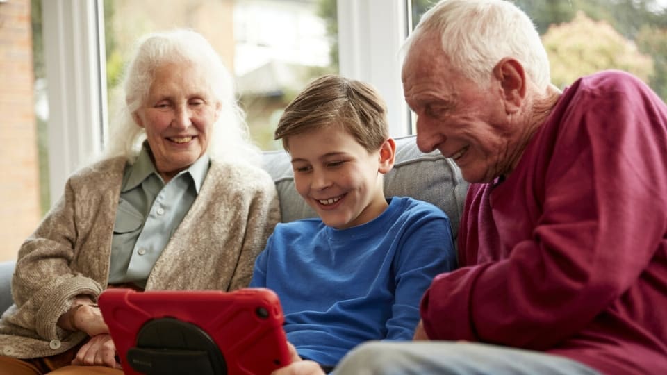 grandparents playing video games with their grandson