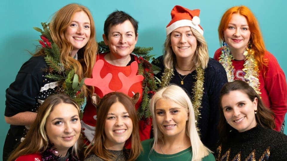 the community fundraising team in a grouped pose wearing festive clothes