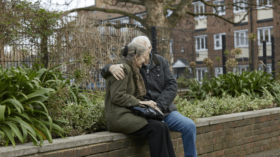 couple sitting outside smiling