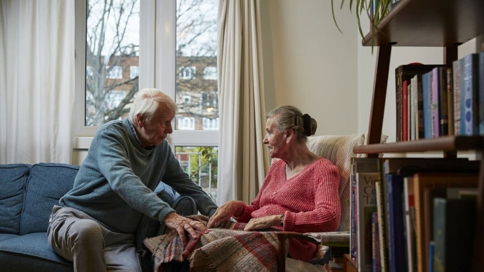 elderly copule sitting together