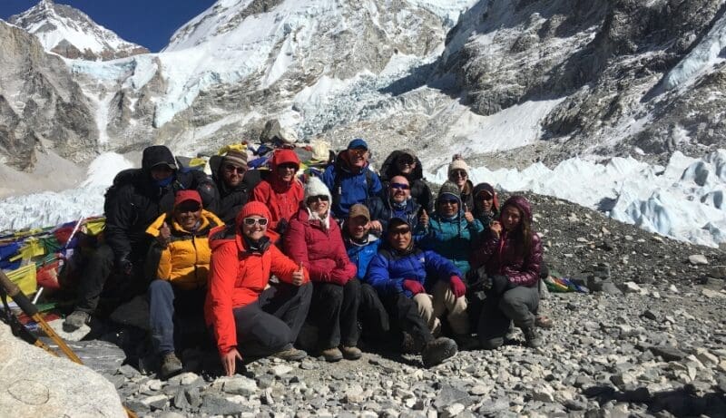 group of people sitting at everest base camp