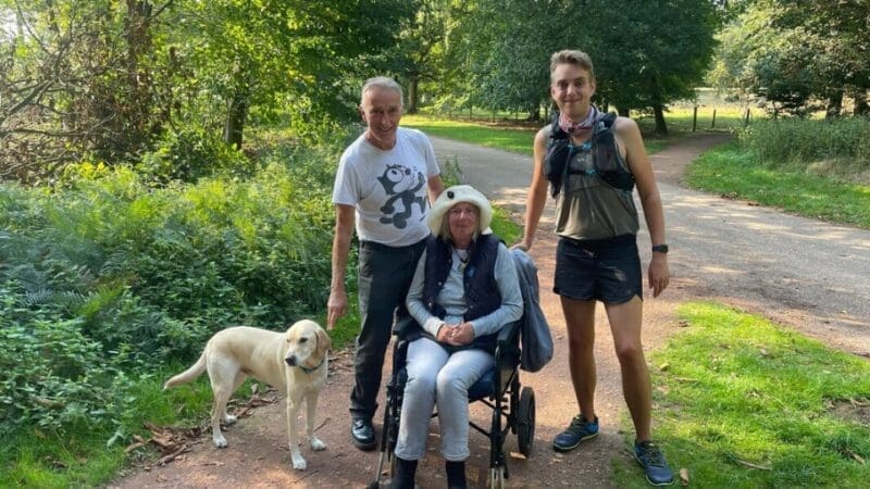 George Bartlett with his mum and dad and dog. In the park.