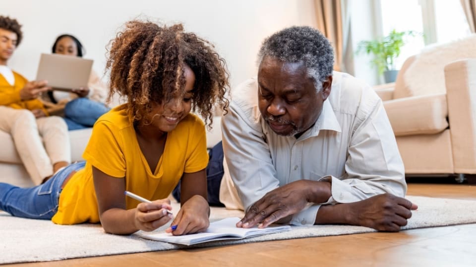 Father and daughter doing a crossword together