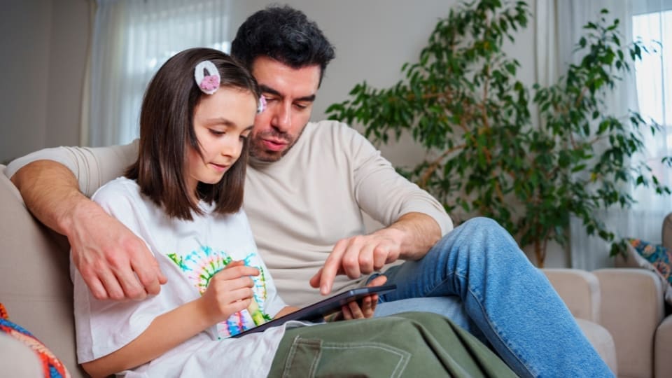 Dad sitting with his daughter