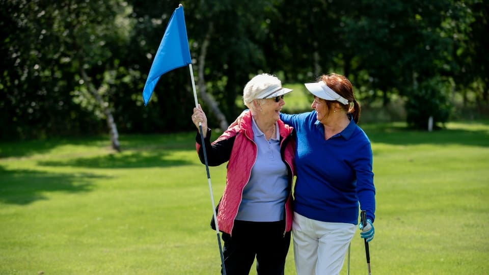 two women playing golf