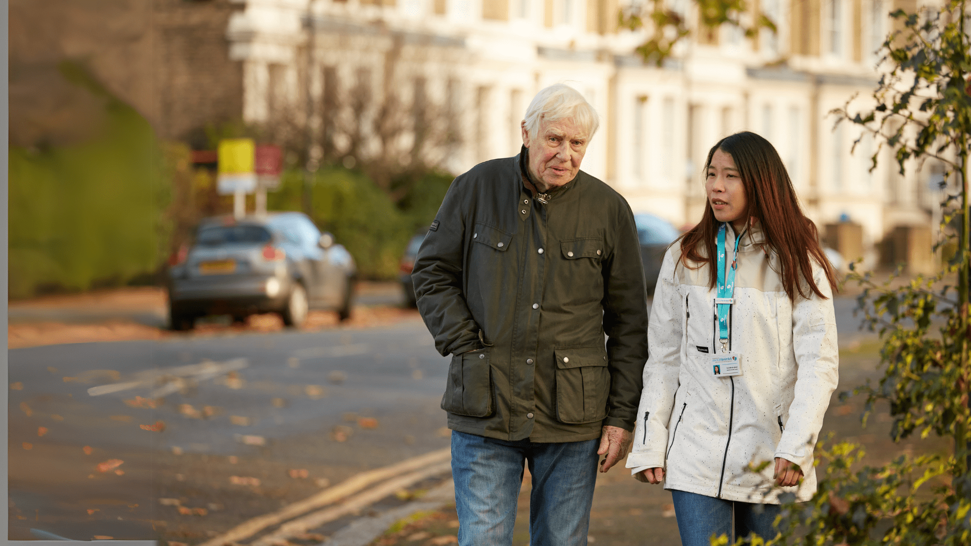 family carer and Admiral Nurse walking along the road.