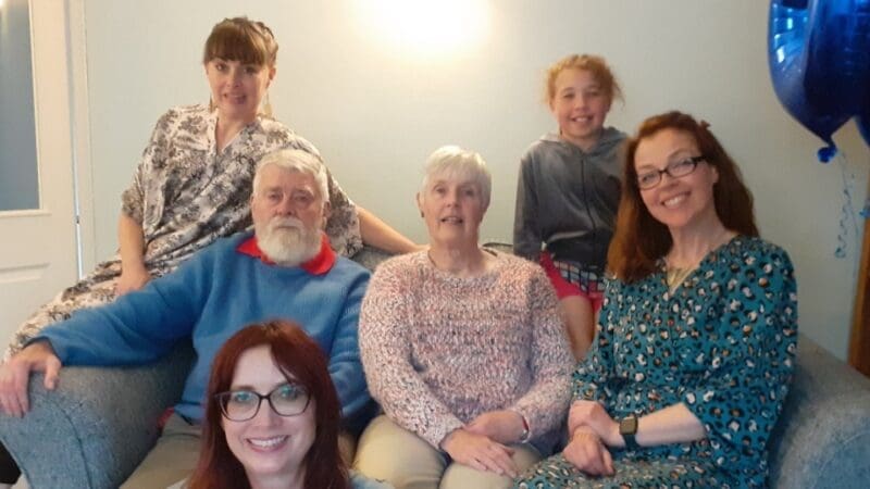 storyteller Jacqui with her husband John and their family all sitting together