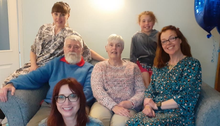 storyteller Jacqui with her husband John and their family all sitting together