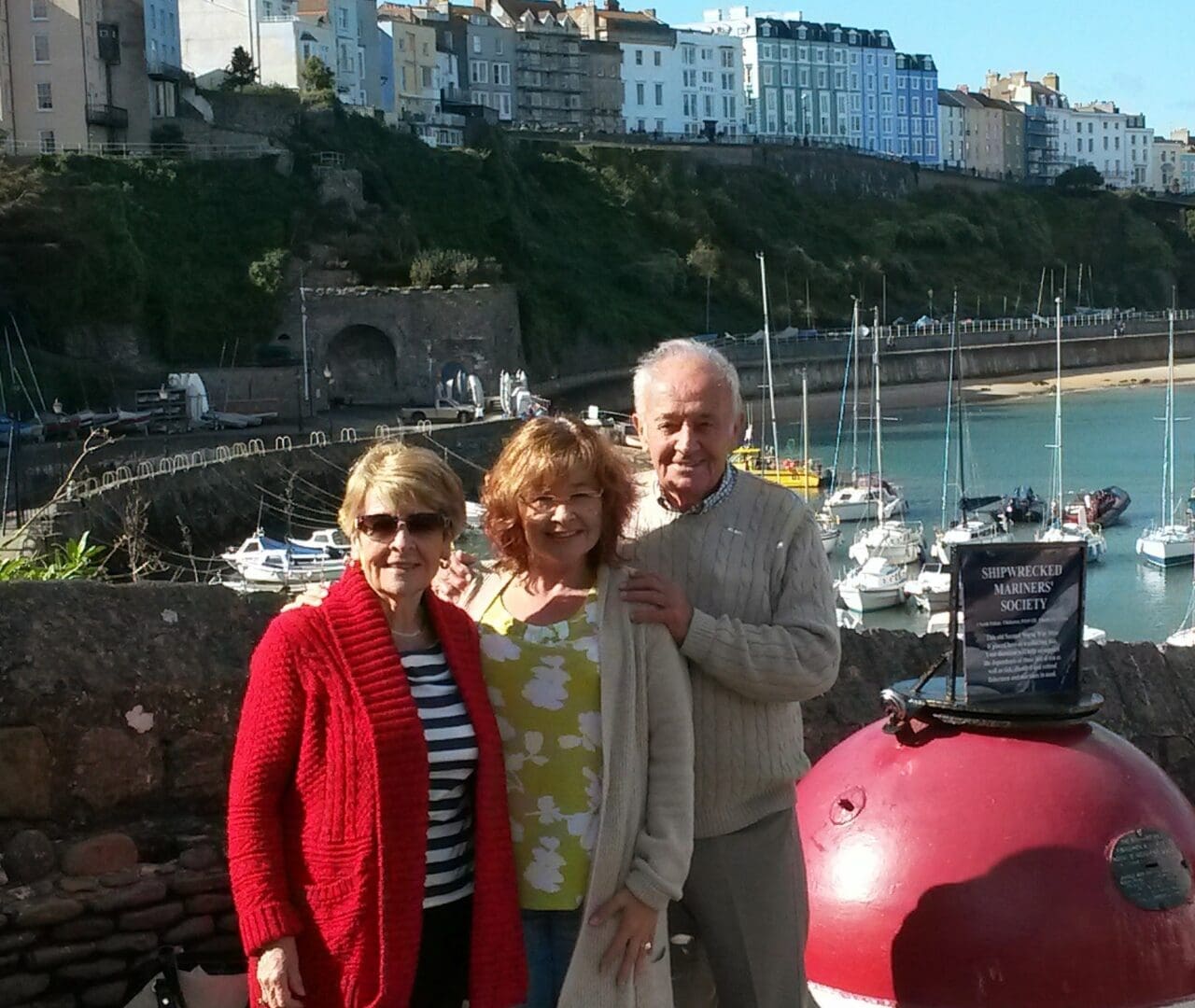 Storyteller Claire standing with he mum and dad at the coastline