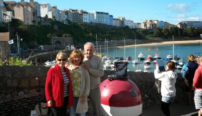 Storyteller Claire standing with he mum and dad at the coastline
