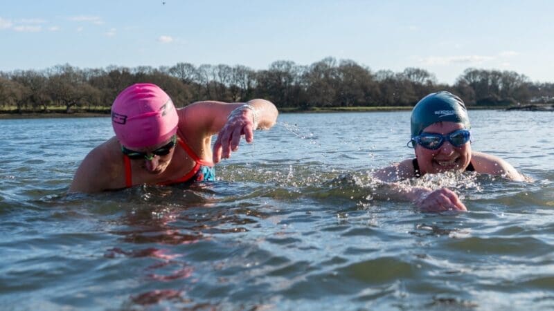 two people swimming in open water