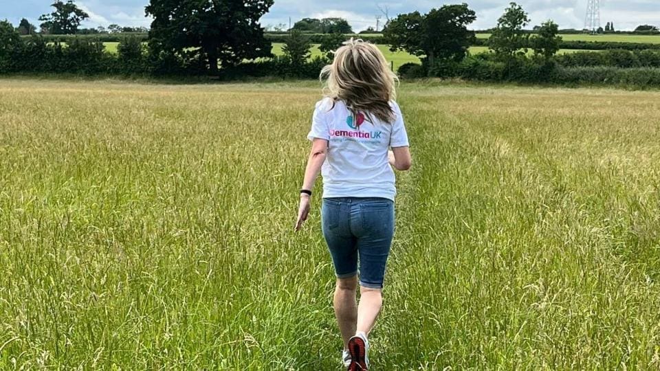 person walking through a field