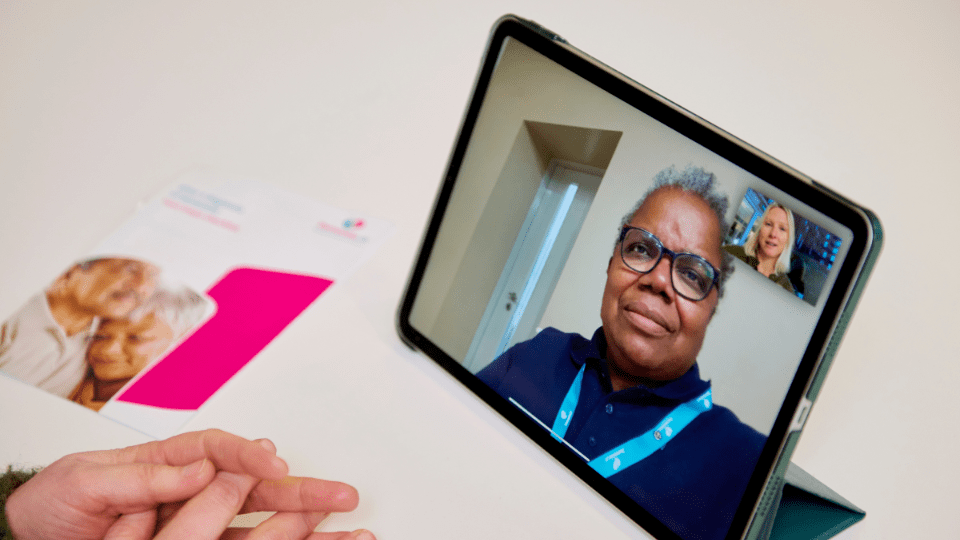 A person talking to an Admiral Nurse on a tablet